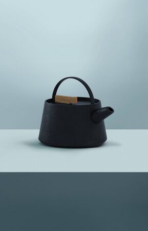 Modern black cast iron teapot with colorful minimalist background blue, art set for tea time. 3d rendering.の写真素材