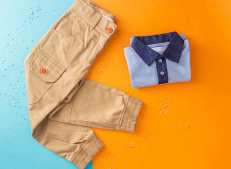 Top view fashion trendy look of boys clothes and shoes, fashion concept, outfit, colors background, Stylish child look.の写真素材