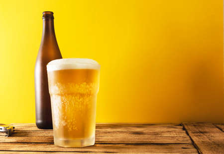 Beer glass, bottle beer on a wooden background, selective focus.の写真素材