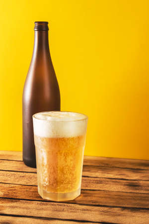 Beer glass, bottle beer on a wooden background, selective focus.の写真素材