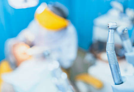 Dental tools and equipment, close-up dental instruments, Cute woman sits in dentist chair while dentist examine her teeths. Selective focus.の写真素材