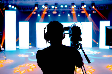 Professional cameraman - covering on event with a video, cameraman silhouette on live studio news,...