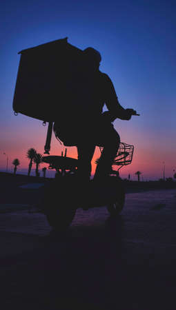 Silhouette bike on sunset and bicycle delivery background. Cyclists against the sky at sunset. Selective focusの写真素材