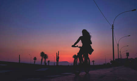 Silhouette bike on sunset and bicycle background. Cyclists against the sky at sunset. Selective focusの写真素材