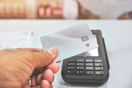 Close up of unrecognizable customer doing a contactless payment, Paying made simple