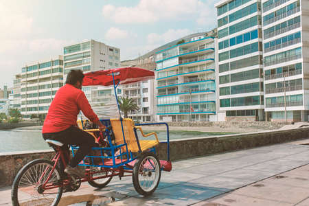 Taxy bike - Tricycle taxi on the boulevard by the pier in Ancon, Peru, sunny day. New normal conceptの写真素材