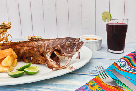 Peruvian cuisine: Cabrilla frita, fried fish. Selective Focus