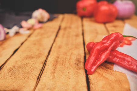 Peruvian ingredients: Rocoto Chili Which Has Been Sliced On A Wooden Board, chili AjÃ­ Limo,...