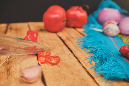Peruvian ingredients: Vegetables with cutting board, Rocoto Chili Which Has Been Sliced On A Wooden Board, chili AjÃ­ Limo, garlic and onionの写真素材