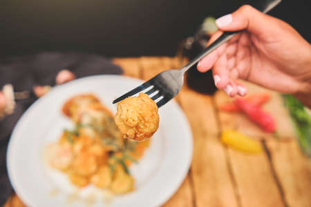 Peruvian food: Sauteed Shrimp with Herbs and Garlic, wooden table, served on a white plate, accompanied by purple corn juiceの写真素材