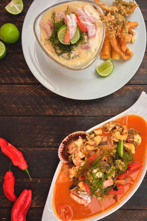 Peruvian food: called "Leche de tigre" and "chicharron", Peruvian fresh fish on glass (Raw fish cocktail ceviche with lime, grinder, chili and cilantro). Selective focusの写真素材