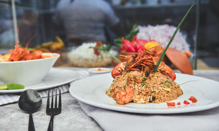 Peruvian food: called "Arroz chaufa" with seafood and "Chupe de Camarones" Prawns soup. Top view. Selective focusの写真素材