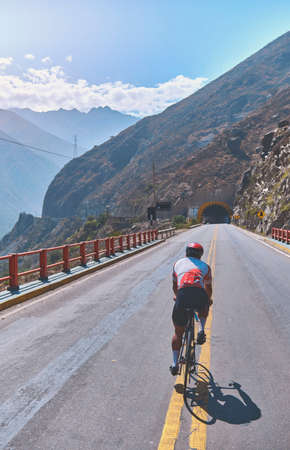 Photo of road cycling. Triathlete train in beautiful nature. Sea and mountains in the background. Matucana, Peruの写真素材