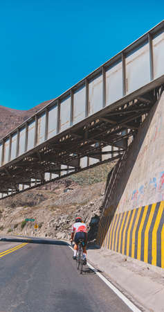 Photo of road cycling. Triathlete train in beautiful nature. Sea and mountains in the background. Matucana, Peruの写真素材