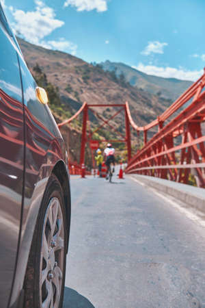 Professional cyclist training on the road with safety escort car. Cyclist followed by team car. Selective focusの写真素材