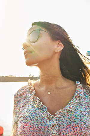 Beautiful young woman in luxury yacht bay, ready to sail. Summer conceptの写真素材