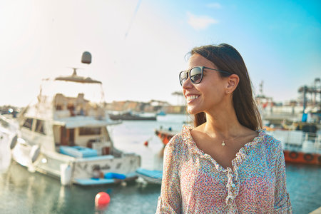 Beautiful young woman in luxury yacht bay, ready to sail. Summer conceptの写真素材