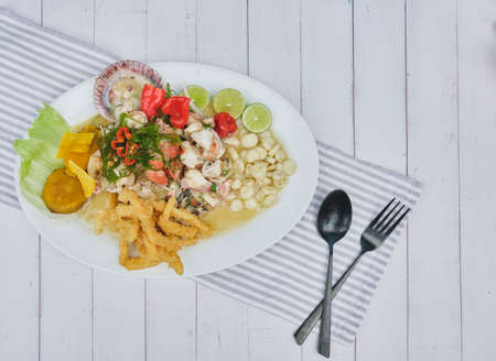Typical Peruvian food, squid ceviche, shrimp, crab and white fish with purple onion and a good tiger milk.の写真素材