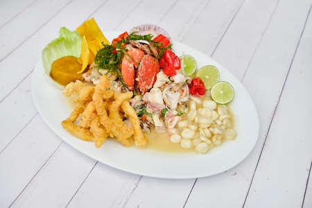 Typical Peruvian food, squid ceviche, shrimp, crab and white fish with purple onion and a good tiger milk.の写真素材