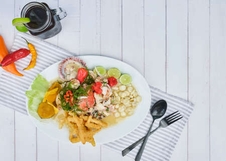 Typical Peruvian food, squid ceviche, shrimp, crab and white fish with purple onion and a good tiger milk.の写真素材