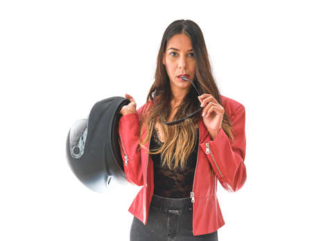 Beautiful empowered motorcyclist woman with modern look. Power woman conceptの写真素材