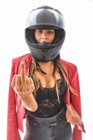 Motorcyclist woman showing the middle finger making you screw the bad expression, Power woman concept.の写真素材