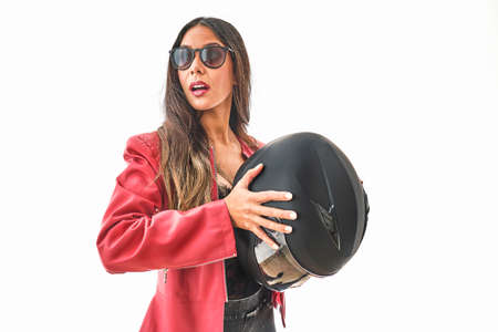 Beautiful young woman smiling in protective motorcycle helmet in studio, Power woman concept.の写真素材