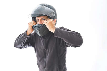 Man with a motorcycle helmet giving a thumbs up gesture, Isolated on white studio wallの写真素材