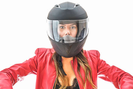 Beautiful young woman in protective motorcycle helmet in studio, Power woman concept.の写真素材