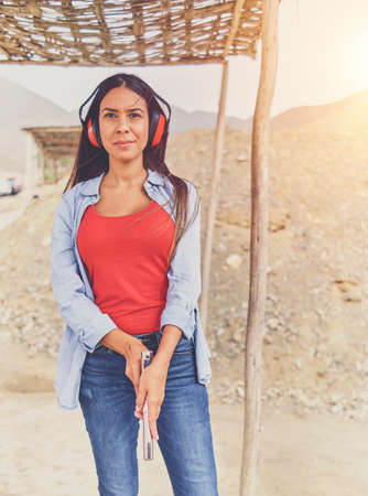 Woman releasing stress, Instructor helping woman with gunの写真素材