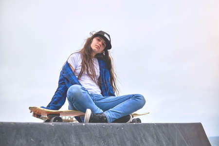 Girl having fun riding skateboards at skate park, Portrait of smiling young female skateboarder...