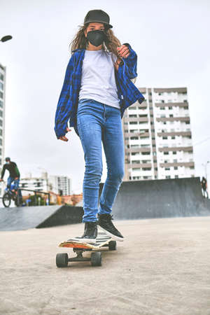 Girl having fun riding skateboards at skate park, Portrait of smiling young female skateboarder...