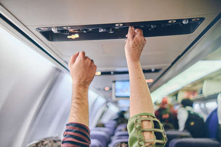 Hand up to adjust console panel aircraft, selective focus. Travel conceptの写真素材