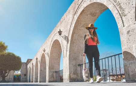 Beautiful smiling woman enjoying on vacation in Yamahuara viewpoint, Arequipa, Peru. Selective Focus.の写真素材