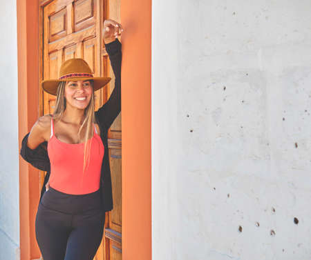 Beautiful smiling woman enjoying on vacation. Portrait of happy woman using hat. Shes got styleの写真素材