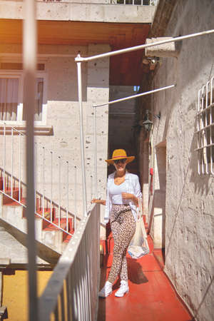 Beautiful smiling woman enjoying on vacation. Portrait of happy woman using hat. Selective Focus.の写真素材