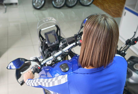 Lima, Peru - Sep 2022: Pretty Latin model presenting a Yamaha Tenere 700 in a Yamaha motorcycle...