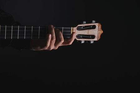 Another chords. String Cuatro instrument recording session, closeup, artist playing Venezuelan folk music with 4 stringsの写真素材