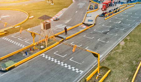 Aerial top view of the go-kart track from the drone. Kart racers drive on the open track.の写真素材