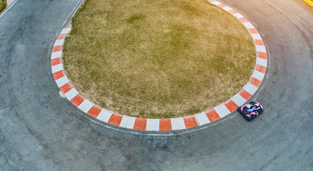 Aerial top view of the go-kart track from the drone. Kart racers drive on the open track.の写真素材