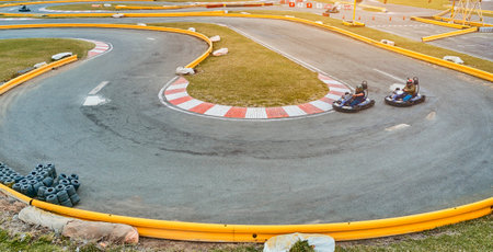 A driver in gear and helmet drives a racing car. Go karts racing, street karting, rent, copy spaceの写真素材