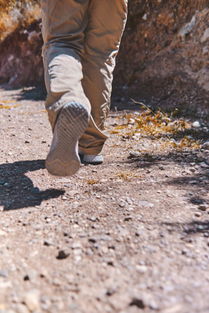 Young tourist walks on a path to the mountain. adventure travel, hiking concept.