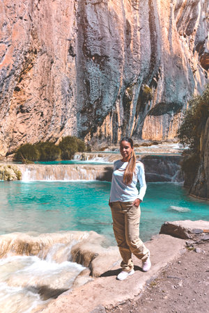 Young woman at viewpoint of the natural pools of Millpu, Ayacucho, Peru. Concept about travelの写真素材