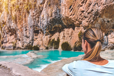 Young woman at viewpoint of the natural pools of Millpu, Ayacucho, Peru. Concept about travelの写真素材