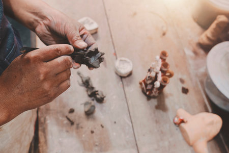 Man molding clay to make ceramics with his hands, Artisan working in his workshop, Selective Focusの写真素材