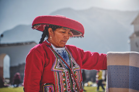 Peruvian woman selling souvenirs at Inca ruins, Sacred Valley, Peruの写真素材