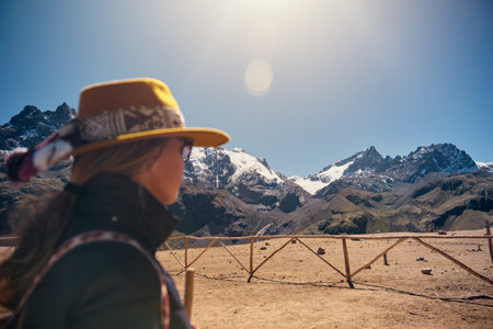 traveler girl in hat with exploring sunny peruvian andes, South Americaの写真素材