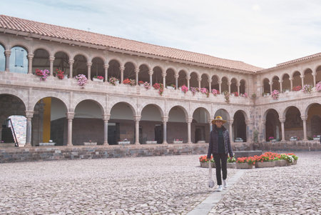 Girl exploring The Temple of the Sun of the Incas or Coricancha, Qorikancha, Cusco, Peruの写真素材