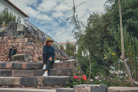 Tourist with Hat exploring in Qorikancha Inner Gardens. Cusco, Peruの写真素材