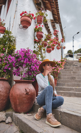 Travels in South America. Girl sitting on stairs Siete Borreguitos street from Cusco city in Peru, Travel conceptの写真素材